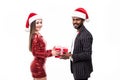 Christmas holiday happy asian couple hold present gift box wear red new year santa hat cap, indian man and asian woman love smile Royalty Free Stock Photo