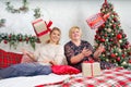 Christmas holiday happy girl friends exchanging presents. Two girlfriends exchanging christmas presents Royalty Free Stock Photo