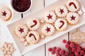 Christmas holiday jam filled cookies, top view table scene against white wood Royalty Free Stock Photo