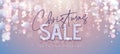 Christmas holiday sale banner with modern glowing blurred lamps on silver background