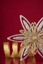 Christmas holiday snowflake and silver ribbon on dark red background Royalty Free Stock Photo