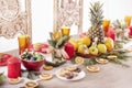 Christmas holiday table decorated with candles, Christmas tree branches, dried oranges, sweets and fruits,selective focus.Cozy Royalty Free Stock Photo