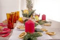 Christmas holiday table decorated with candles, Christmas tree branches, dried oranges, sweets and fruits,selective focus.Cozy Royalty Free Stock Photo