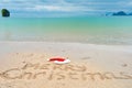 Christmas holiday tropical vacation concept, Merry Christmas written on tropical beach sand and sea background