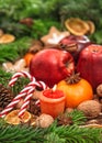 Christmas holidays backdround. Fruits, spices and candles Royalty Free Stock Photo