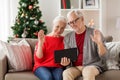 Happy senior couple with tablet pc at christmas Royalty Free Stock Photo