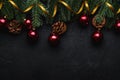 Christmas holidays composition. Golden ribbon, red ornament and bauble decorations, fir-tree and pine cones. Royalty Free Stock Photo