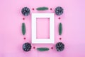 Christmas holidays composition, top view of red Christmas decorations and picture frame on pink background with copy space for Royalty Free Stock Photo