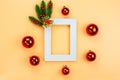 Christmas holidays composition, top view of red Christmas decorations and picture frame on yellow background with copy space for Royalty Free Stock Photo