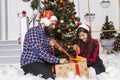 Christmas holidays concept photography of happy and glad couple bearded man and cheerful young woman near decorated tree with Royalty Free Stock Photo