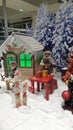 Christmas holidays creative decoration for shops using wood houses fake snow and dolls