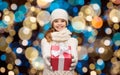 Happy girl in winter clothes with gift box Royalty Free Stock Photo