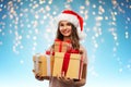 Teenage girl in santa hat with christmas gift Royalty Free Stock Photo