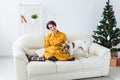 Christmas, holidays and people concept - happy young woman reading book at home Royalty Free Stock Photo