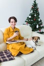 Christmas, holidays and people concept - happy young woman reading book at home Royalty Free Stock Photo