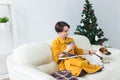 Christmas, holidays and people concept - happy young woman reading book at home. Royalty Free Stock Photo