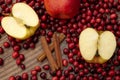 Christmas and holidays recipes, mulled wine ingredients and seasonal cooking concept with sliced red apples, heap of cranberries