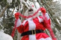 Christmas holidays. Santa Gloves and Tinsel. Santa Claus decorates a Christmas tree