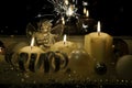 Christmas holidays symbol, decorative candles burning, a silver angel and a sprinkler on a black background