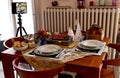 Christmas holidays table with tablet on tripod to enjoy distant communication with family during the Covid-19 pandemic