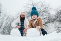 Christmas holidays and winter new year with father and son. Happy father and son making snowman in the snow. Handmade Royalty Free Stock Photo