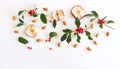 Christmas holly with red berries, dried apple slices, and almonds. Traditional festive decoration. Holly branch with red berries Royalty Free Stock Photo