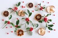 Christmas holly with red berries, dried apple slices and oranges. Traditional festive decoration. Holly branch with red berries on Royalty Free Stock Photo