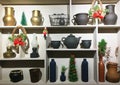 Christmas home decor as part of the interior, home utensils clay pots, old lamps, Christmas wreath, artificial Christmas tree on