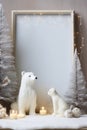 Christmas home decor with candles, figures of bears, empty picture frame and Christmas ornaments on table Royalty Free Stock Photo