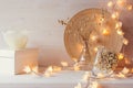 Christmas home decoration with burning lights on white wooden background. Royalty Free Stock Photo