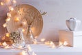 Christmas home decoration with burning lights on white wooden background. Royalty Free Stock Photo