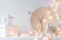 Christmas home decoration with burning lights on white wooden background. Royalty Free Stock Photo