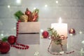 Christmas home decoration. Burning white candle and Christmas interior decorations on table Royalty Free Stock Photo