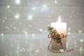 Christmas home decoration. Burning white candle and Christmas interior decorations on table Royalty Free Stock Photo