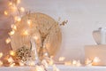 Christmas home decoration with lights on white wooden background. Royalty Free Stock Photo