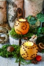 Christmas home decoration with pomander, candles, moss and paradise apples Royalty Free Stock Photo
