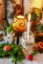 Christmas home decoration with pomander, candles, moss and paradise apples Royalty Free Stock Photo