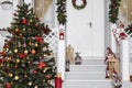 Christmas home facade festive decoration view colorful toys and objects near building porch in white red and green colorful Royalty Free Stock Photo