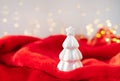 Christmas home interior with a white ceramic Christmas tree on a red blanket. Christmas and New Year concept Royalty Free Stock Photo