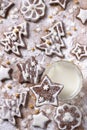 Christmas homemade chocolate cookies decorated with icing and powdered sugar with milk on a wooden background Royalty Free Stock Photo