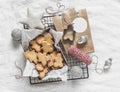 Christmas homemade edible gift - butter cookies and Christmas decor on a light background, top view