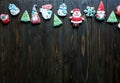 Christmas homemade gingerbread cookies, spices on the plate on dark wooden background among Christmas presents