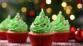 Christmas homemade muffins as Xmas tree with green whipped cream on bokeh background, Close up Royalty Free Stock Photo