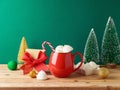 Christmas Hot Chocolate Cup With Marshmallow, Gift Box And Decorations On Wooden Table Over Green Background. Festive Greeting