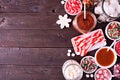 Christmas hot cocoa buffet with assorted sweet toppings. Side border on a dark wood background. Royalty Free Stock Photo