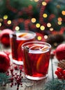 Christmas hot cranberry tea, orange pomegranate punch or mulled wine in a rustic wooden table. Closeup. Royalty Free Stock Photo