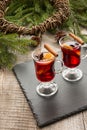 Christmas hot mulled wine with cinnamon, orange and christmas tree on board. Close up. Winter tradition drink. Royalty Free Stock Photo