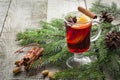 Christmas hot mulled wine with cinnamon, orange and christmas tree on board. Winter tradition drink. Royalty Free Stock Photo