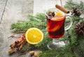 Christmas hot mulled wine with cinnamon, orange and christmas tree on wooden board. Winter tradition drink. Royalty Free Stock Photo