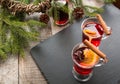 Christmas hot mulled wine with cinnamon and christmas tree on black slate dish. Copy space. Royalty Free Stock Photo